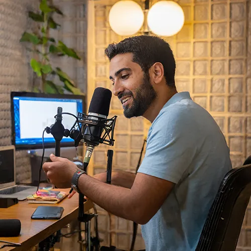 a youtuber editing a video with captivating visuals and a microphone indicating voiceover work, set in a cozy, creative home studio environment