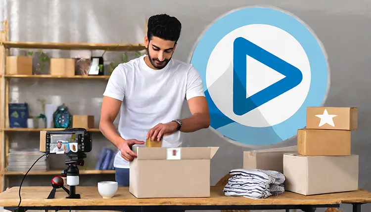  a man packing branded merchandise like t-shirts and mugs into boxes